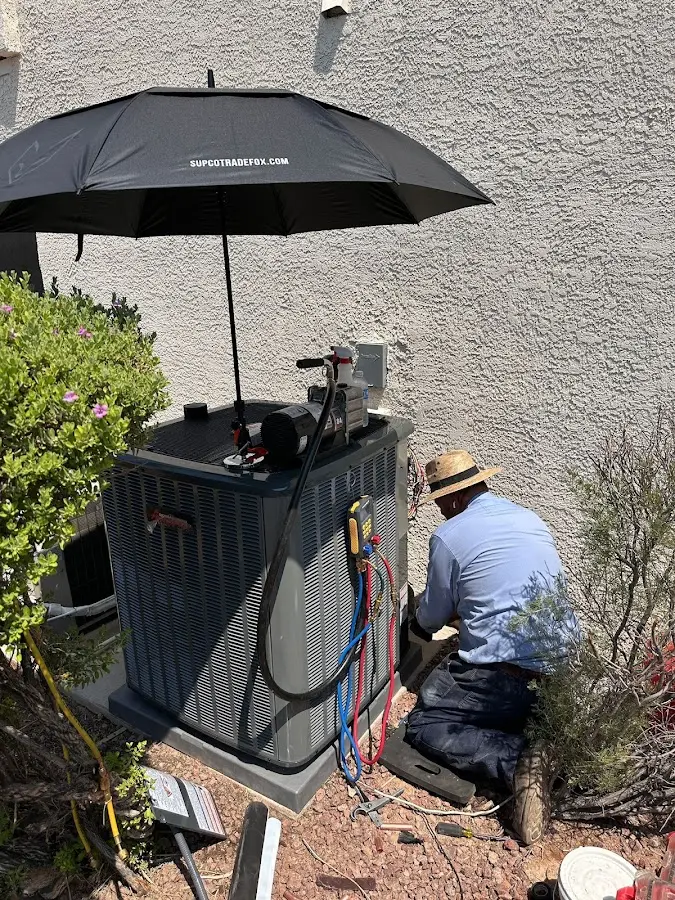 HVAC technician performing outdoor AC maintenance in Gulfport